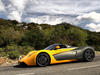 Marussia B1 на загородной трассе, вид сбоку